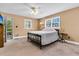 Neutral bedroom featuring a bed, dresser, ceiling fan, and natural light from two windows at 107 Jacks Ln, Bonneau, SC 29431