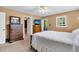 Neutral bedroom featuring a bed, dresser, ceiling fan, and a door leading to a porch at 107 Jacks Ln, Bonneau, SC 29431
