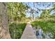 Picturesque view of boardwalk through marsh and water leading to lake at 107 Jacks Ln, Bonneau, SC 29431