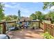 Open-air wooden deck with outdoor seating and potted plants, great for relaxing and enjoying the view at 107 Jacks Ln, Bonneau, SC 29431