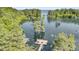 Aerial view of a private dock on the lake, featuring a wooden platform with a picnic table and canoe at 107 Jacks Ln, Bonneau, SC 29431