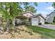 Home featuring a two car garage, carport, well-maintained lawn, and lush landscaping at 107 Jacks Ln, Bonneau, SC 29431