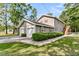 Charming two-story home with a well-manicured lawn, attached two-car garage and lush landscaping at 107 Jacks Ln, Bonneau, SC 29431