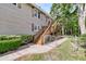 Side view of a house with a wooden staircase leading to an elevated deck and a fenced yard at 107 Jacks Ln, Bonneau, SC 29431