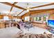 Spacious living room features wood walls, a ceiling fan, and a large window to the screened in porch at 107 Jacks Ln, Bonneau, SC 29431