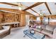 Spacious living room featuring wood paneling, exposed beams, a built-in bookshelf, and plush furniture at 107 Jacks Ln, Bonneau, SC 29431