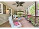 Relaxing porch seating area with ceiling fans and views of the lush surroundings at 107 Jacks Ln, Bonneau, SC 29431