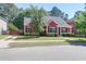 Charming red home with black shutters, manicured landscaping, and inviting front porch at 1126 Rearick Rd, Johns Island, SC 29455