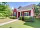 Inviting red home with manicured landscaping and covered porch at 1126 Rearick Rd, Johns Island, SC 29455