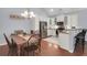 Bright kitchen and dining area with white cabinets, stainless steel appliances, and seating at the counter at 1126 Rearick Rd, Johns Island, SC 29455