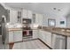 Bright kitchen with white cabinets, granite countertops, stainless steel appliances, and a modern backsplash at 1126 Rearick Rd, Johns Island, SC 29455