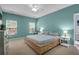 Inviting bedroom with a wooden bed frame, bright windows, and a ceiling fan at 1126 Rearick Rd, Johns Island, SC 29455