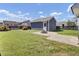 A backyard featuring a storage shed, green grass, a black fence and a small stone fire pit at 117 Red Leaf Blvd, Moncks Corner, SC 29461