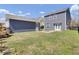 This backyard features a storage shed, main house, a small fire pit, green grass, and a black fence at 117 Red Leaf Blvd, Moncks Corner, SC 29461