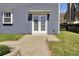 Exterior view of a home featuring a double door leading to a stone patio and backyard, perfect for outdoor living at 117 Red Leaf Blvd, Moncks Corner, SC 29461