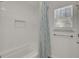 Bright bathroom featuring a shower with blue patterned curtain and an adjacent window at 117 Red Leaf Blvd, Moncks Corner, SC 29461