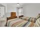 Bright bedroom featuring twin beds, wood furnishings, neutral walls, and a window, creating a serene and inviting atmosphere at 117 Red Leaf Blvd, Moncks Corner, SC 29461
