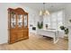 Bright dining room with wood floors, a china cabinet, a modern table with a white top and brown legs at 117 Red Leaf Blvd, Moncks Corner, SC 29461