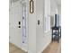 Bright entryway with a white front door with glass and sidelight, a black door handle and a decorative mirror at 117 Red Leaf Blvd, Moncks Corner, SC 29461