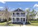 The two-story traditional home offers double porches, landscaped front yard and excellent curb appeal at 117 Red Leaf Blvd, Moncks Corner, SC 29461