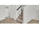 Bright hallway with carpeted stairs, a downstairs bathroom, and hardwood style floors at 117 Red Leaf Blvd, Moncks Corner, SC 29461