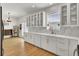 Bright kitchen featuring white cabinets, quartz countertops, stainless steel appliances, and hardwood flooring at 117 Red Leaf Blvd, Moncks Corner, SC 29461