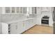 Modern kitchen featuring white cabinets, quartz countertops, stainless steel appliances, and hardwood flooring at 117 Red Leaf Blvd, Moncks Corner, SC 29461