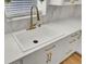 Modern kitchen sink with white countertops and cabinets, and gold faucet and hardware at 117 Red Leaf Blvd, Moncks Corner, SC 29461