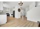 A bright and spacious living room with hardwood floors, white walls, and stainless steel kitchen appliances at 117 Red Leaf Blvd, Moncks Corner, SC 29461