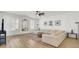 Bright living room with white walls, shuttered windows, a ceiling fan, and comfortable white sectional sofa at 117 Red Leaf Blvd, Moncks Corner, SC 29461