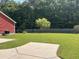 Spacious backyard featuring green grass, mature trees, patio and a privacy fence at 1297 Segar St, Johns Island, SC 29455