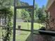 View of a large backyard with lush greenery from a screened porch at 1297 Segar St, Johns Island, SC 29455
