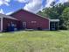 Exterior view of a well-maintained backyard, showing a screened porch and a vibrant lawn at 1297 Segar St, Johns Island, SC 29455