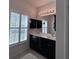Bathroom featuring double sink vanity, large mirror, and natural light from shuttered windows at 1297 Segar St, Johns Island, SC 29455