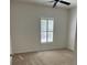 Neutral bedroom with plush carpeting, ceiling fan, and bright window with shutters at 1297 Segar St, Johns Island, SC 29455