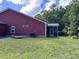 View of the house exterior with a screened-in porch and spacious yard at 1297 Segar St, Johns Island, SC 29455