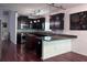 Stylish kitchen with dark cabinetry, granite countertops, and modern lighting fixtures at 1297 Segar St, Johns Island, SC 29455