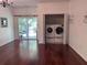 Spacious living room with rich hardwood floors and stainless steel washer/dryer in closet at 1297 Segar St, Johns Island, SC 29455