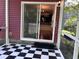 Screened porch with checkered flooring and sliding glass door leading to the home's interior at 1297 Segar St, Johns Island, SC 29455