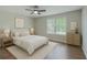 Cozy bedroom with a comfortable bed, soft lighting, and two large windows at 131 Ponderosa Dr, Ladson, SC 29456