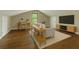 Bright bonus room features hardwood floors, natural light, modern furnishings, and television at 131 Ponderosa Dr, Ladson, SC 29456