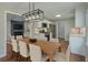 Open concept dining room with modern light fixture open to the kitchen and living spaces at 131 Ponderosa Dr, Ladson, SC 29456