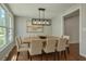 Modern dining room featuring a large dining table with a stylish light fixture and natural light at 131 Ponderosa Dr, Ladson, SC 29456
