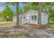 White brick home with a grey roof on a lot with mature trees at 131 Ponderosa Dr, Ladson, SC 29456