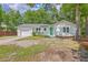 Charming single story home with a white brick exterior and a garage on a large lot at 131 Ponderosa Dr, Ladson, SC 29456