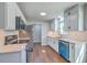 Bright kitchen featuring stainless steel appliances, wooden floors, and white cabinets at 131 Ponderosa Dr, Ladson, SC 29456