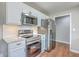 Updated kitchen with stainless steel appliances, white cabinets, and modern countertops at 131 Ponderosa Dr, Ladson, SC 29456