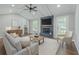 Comfortable living room features a brick fireplace, ceiling fan, and abundant natural light at 131 Ponderosa Dr, Ladson, SC 29456
