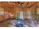 Unfinished interior of wood-framed shed features ceiling fan, door, plywood walls, and natural light at 131 Ponderosa Dr, Ladson, SC 29456