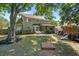 Spacious backyard showcasing a patio, screened porch, play area, and mature trees at 1337 Horseshoe Bnd, Mount Pleasant, SC 29464